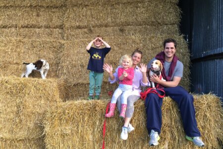 Children and dogs in hay barn