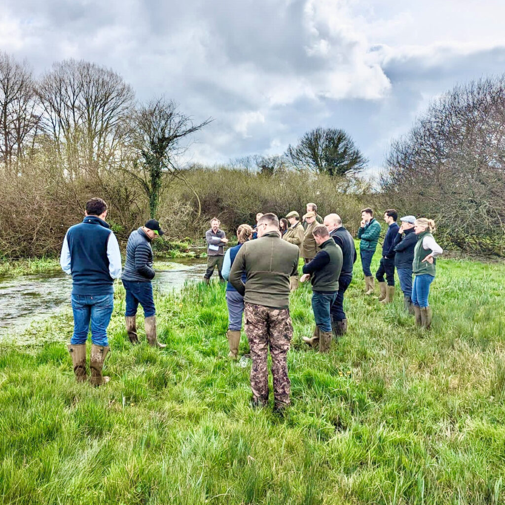 Group standing by a river.