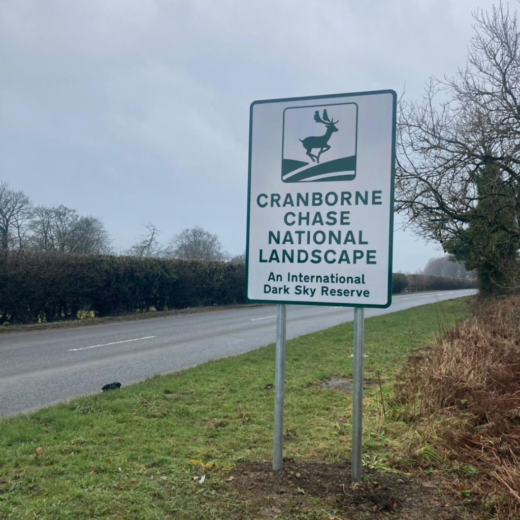 Road sign with deer logo and text